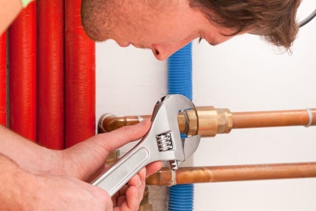 plumber working on copper pipes